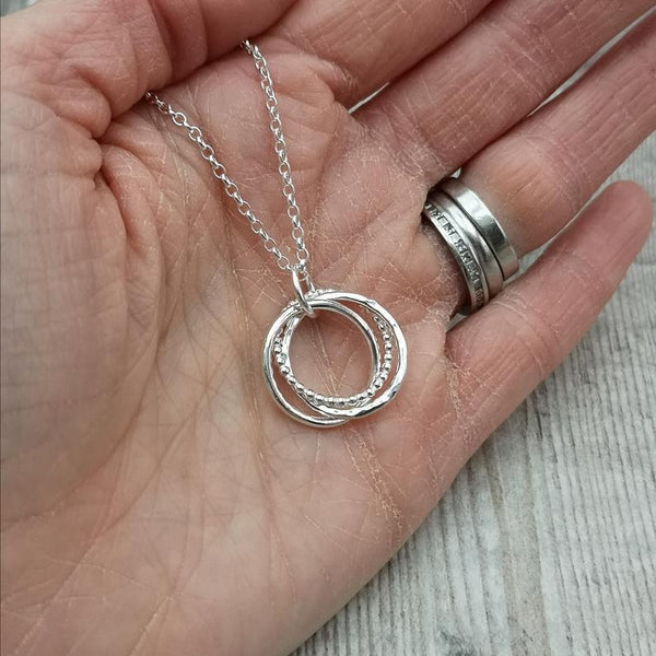 Bristol Silversmith holding a handmade sterling silver necklace